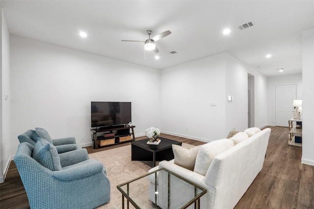 living room with ceiling fan and dark hardwood / wood-style flooring