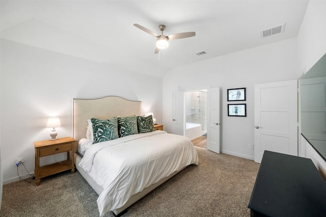 bedroom with ceiling fan, vaulted ceiling, carpet, and connected bathroom