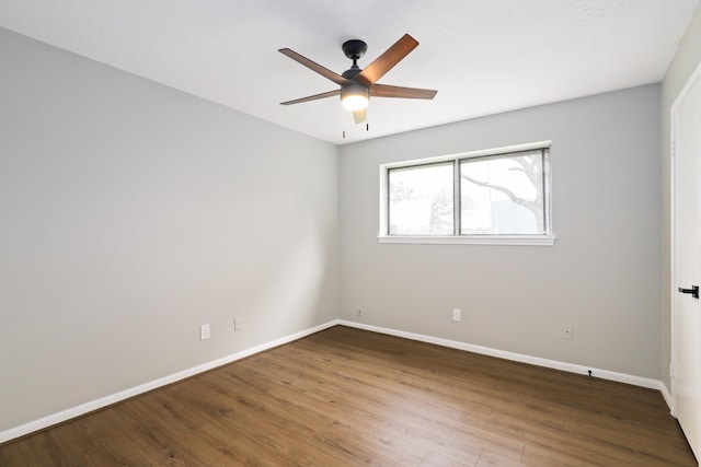 spare room with hardwood / wood-style flooring and ceiling fan