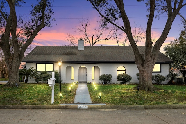 view of front of house with a lawn