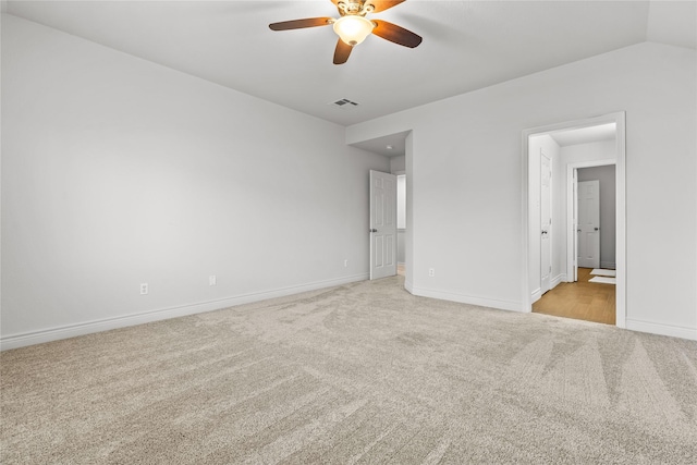 unfurnished bedroom with ceiling fan, light colored carpet, and vaulted ceiling