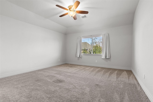 carpeted empty room with vaulted ceiling and ceiling fan