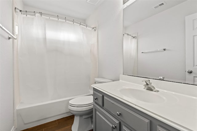 full bathroom featuring toilet, vanity, and shower / bathtub combination with curtain