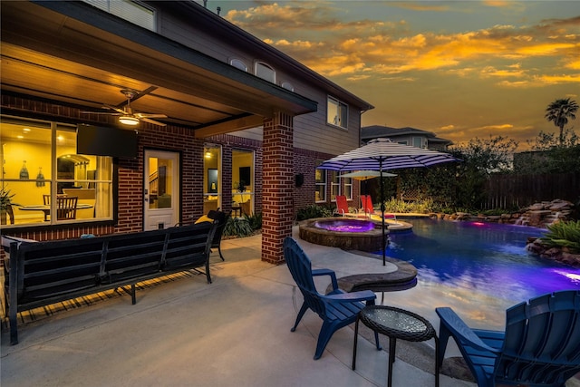 patio terrace at dusk featuring an outdoor living space, a swimming pool with hot tub, and ceiling fan