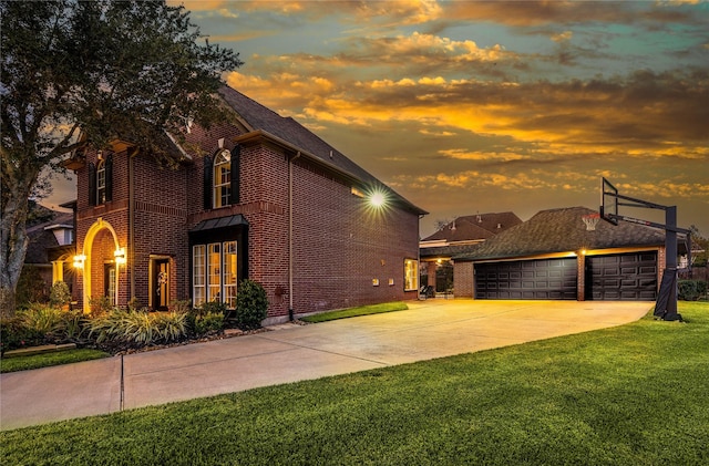 view of front of home featuring a garage and a lawn