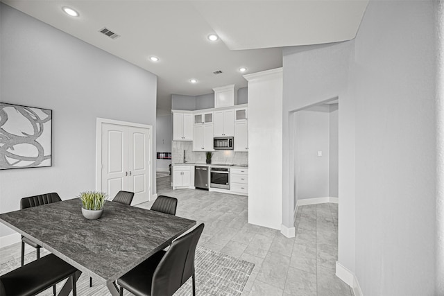 dining area featuring a high ceiling