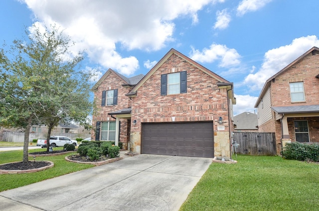 traditional-style home featuring a front yard, a garage, fence, concrete driveway, and brick siding