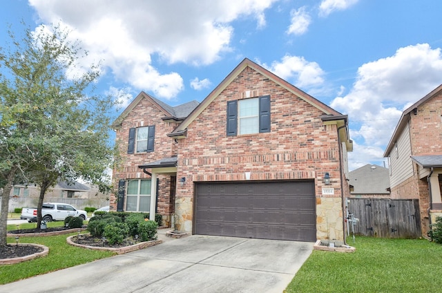 traditional-style house featuring a garage, fence, brick siding, a front lawn, and driveway