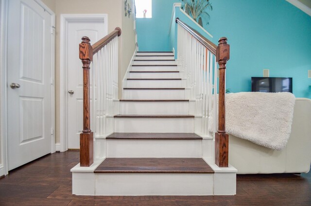 staircase with hardwood / wood-style floors