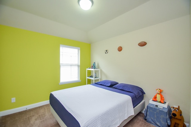 bedroom featuring carpet flooring and lofted ceiling