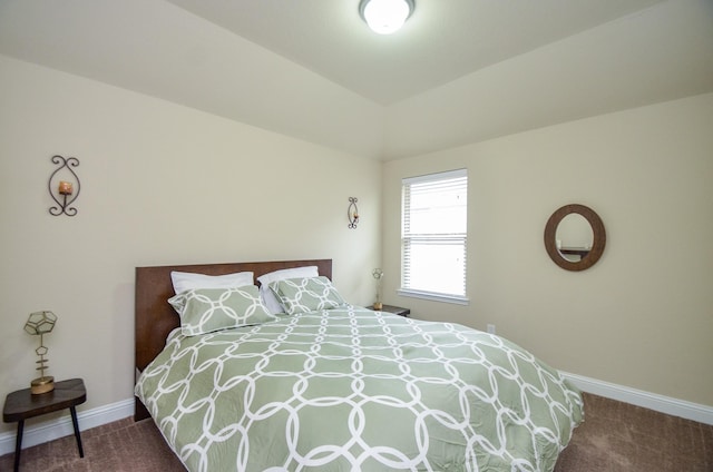 bedroom with vaulted ceiling and carpet flooring