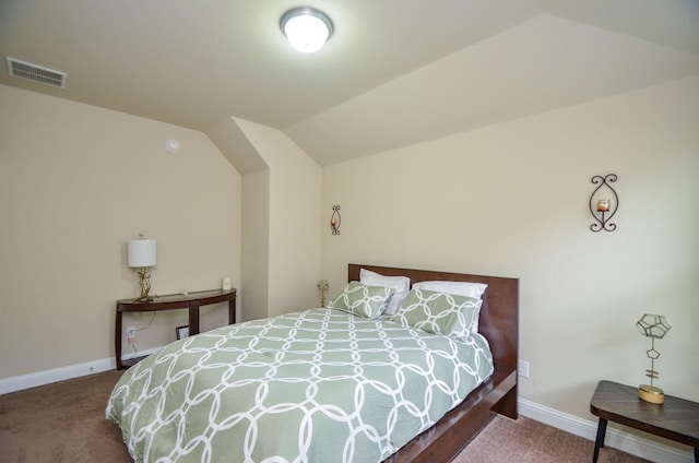 bedroom featuring lofted ceiling and carpet flooring