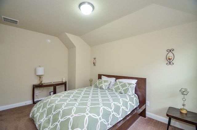 carpeted bedroom with baseboards, vaulted ceiling, and visible vents