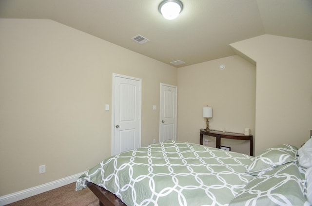 bedroom with carpet floors and vaulted ceiling