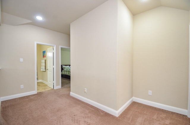 unfurnished room featuring light carpet, recessed lighting, baseboards, and vaulted ceiling