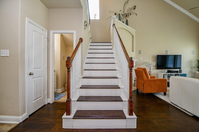 staircase with wood finished floors and baseboards