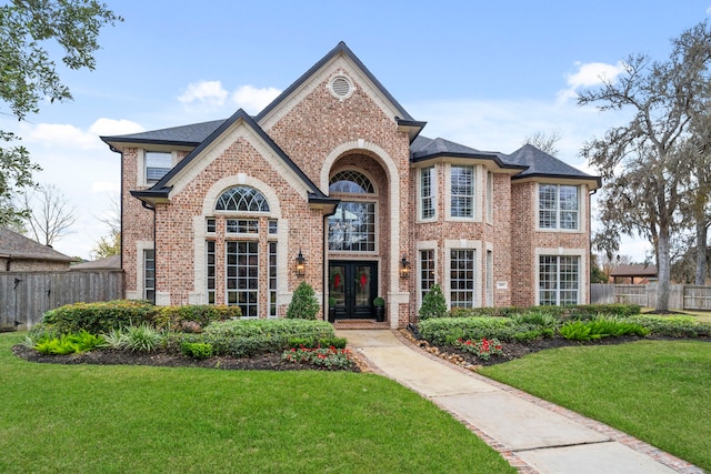 view of front of house with a front yard and french doors