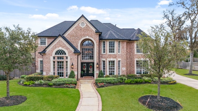 view of front of house featuring a front lawn and french doors