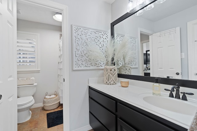 bathroom featuring toilet and vanity