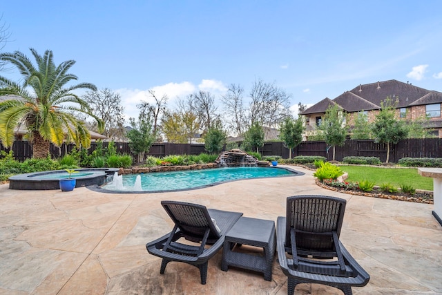 view of swimming pool featuring pool water feature, an in ground hot tub, and a patio