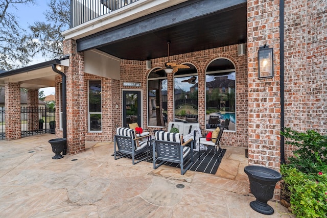 view of patio / terrace with a balcony, an outdoor living space, and ceiling fan