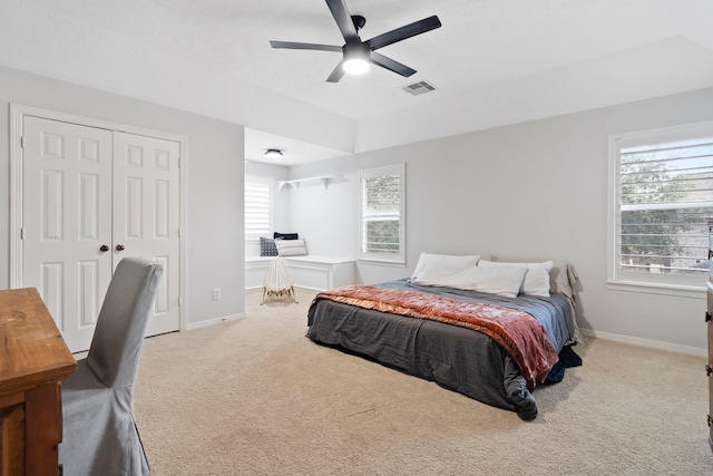 carpeted bedroom featuring a closet and ceiling fan