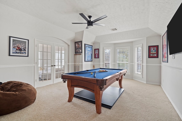 rec room with light carpet, ceiling fan, french doors, and a textured ceiling