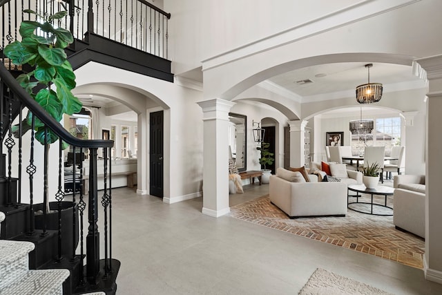 living room with decorative columns and concrete flooring