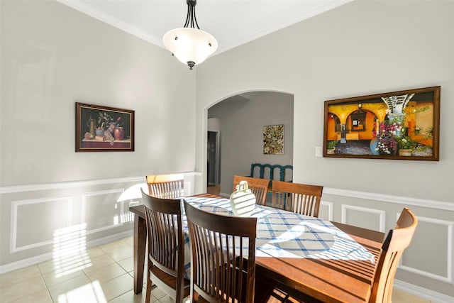 dining space with crown molding and light tile patterned floors