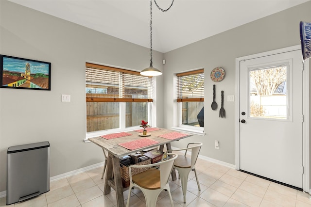 tiled dining space with vaulted ceiling