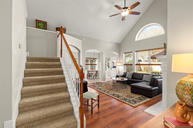 living room featuring ceiling fan, high vaulted ceiling, and hardwood / wood-style floors