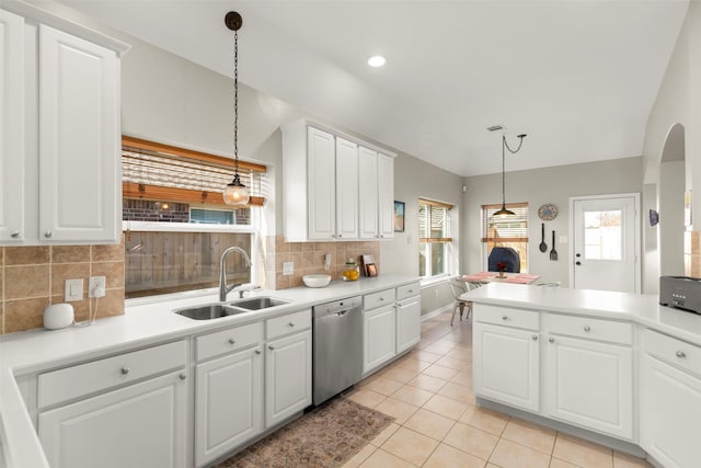 kitchen with hanging light fixtures, white cabinetry, sink, and stainless steel dishwasher