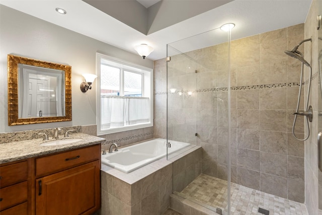 bathroom featuring vanity and shower with separate bathtub