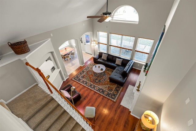 living room with ceiling fan, high vaulted ceiling, and hardwood / wood-style floors