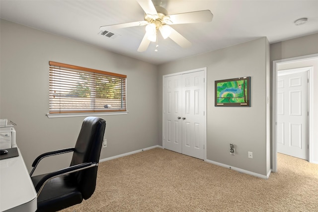 home office with light carpet and ceiling fan