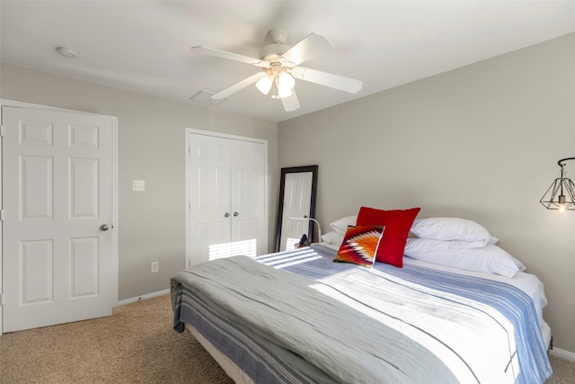 carpeted bedroom with ceiling fan and a closet