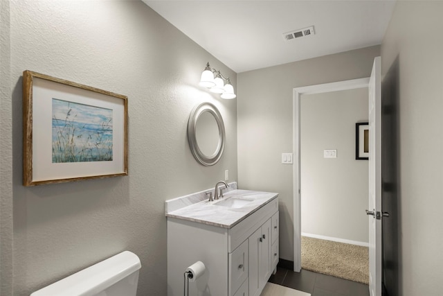 bathroom with vanity, tile patterned floors, and toilet