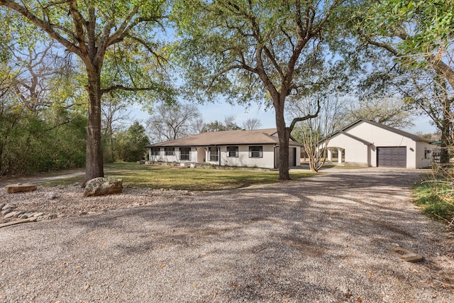 single story home with a front yard and a garage