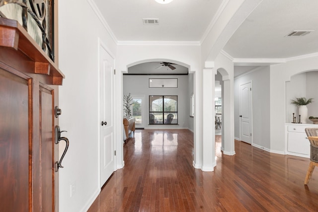 foyer entrance featuring ceiling fan, dark hardwood / wood-style flooring, and crown molding