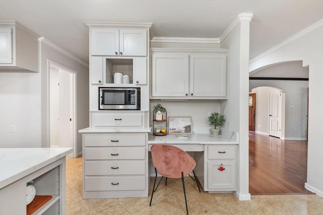 tiled home office with built in desk and crown molding