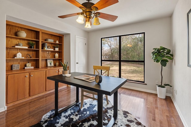 office space featuring ceiling fan, baseboards, and hardwood / wood-style flooring