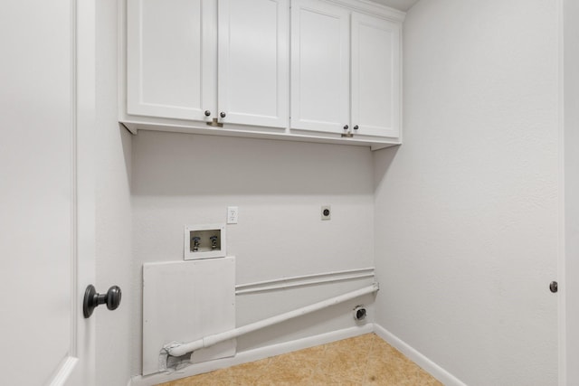 laundry area featuring cabinet space, baseboards, tile patterned floors, hookup for an electric dryer, and washer hookup