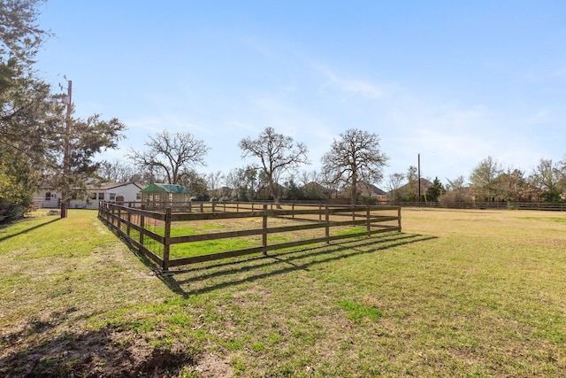 view of yard with a rural view and fence