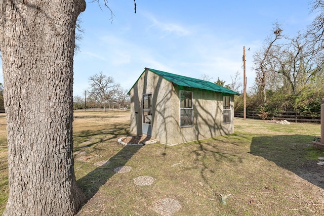 view of outbuilding with a yard