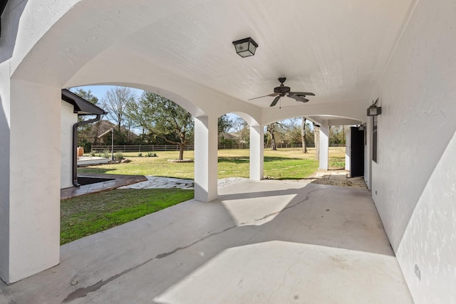 view of patio / terrace with fence and a ceiling fan