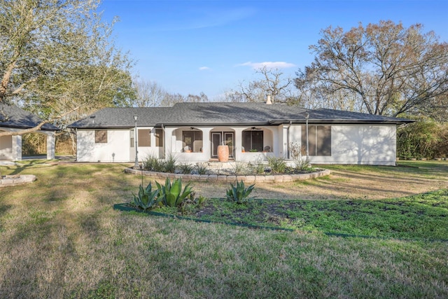 back of property with a ceiling fan and a yard