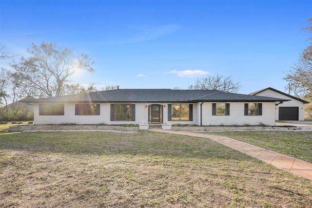 ranch-style house with an attached garage and a front yard