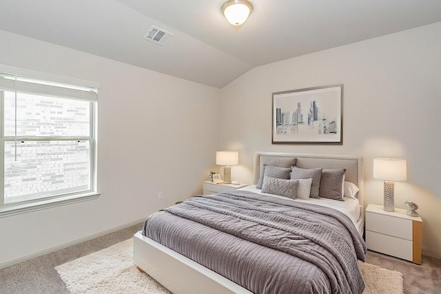 carpeted bedroom with vaulted ceiling