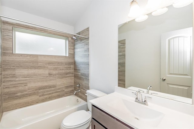 full bathroom featuring toilet, tiled shower / bath combo, and vanity