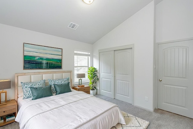 bedroom with vaulted ceiling, a closet, and carpet flooring